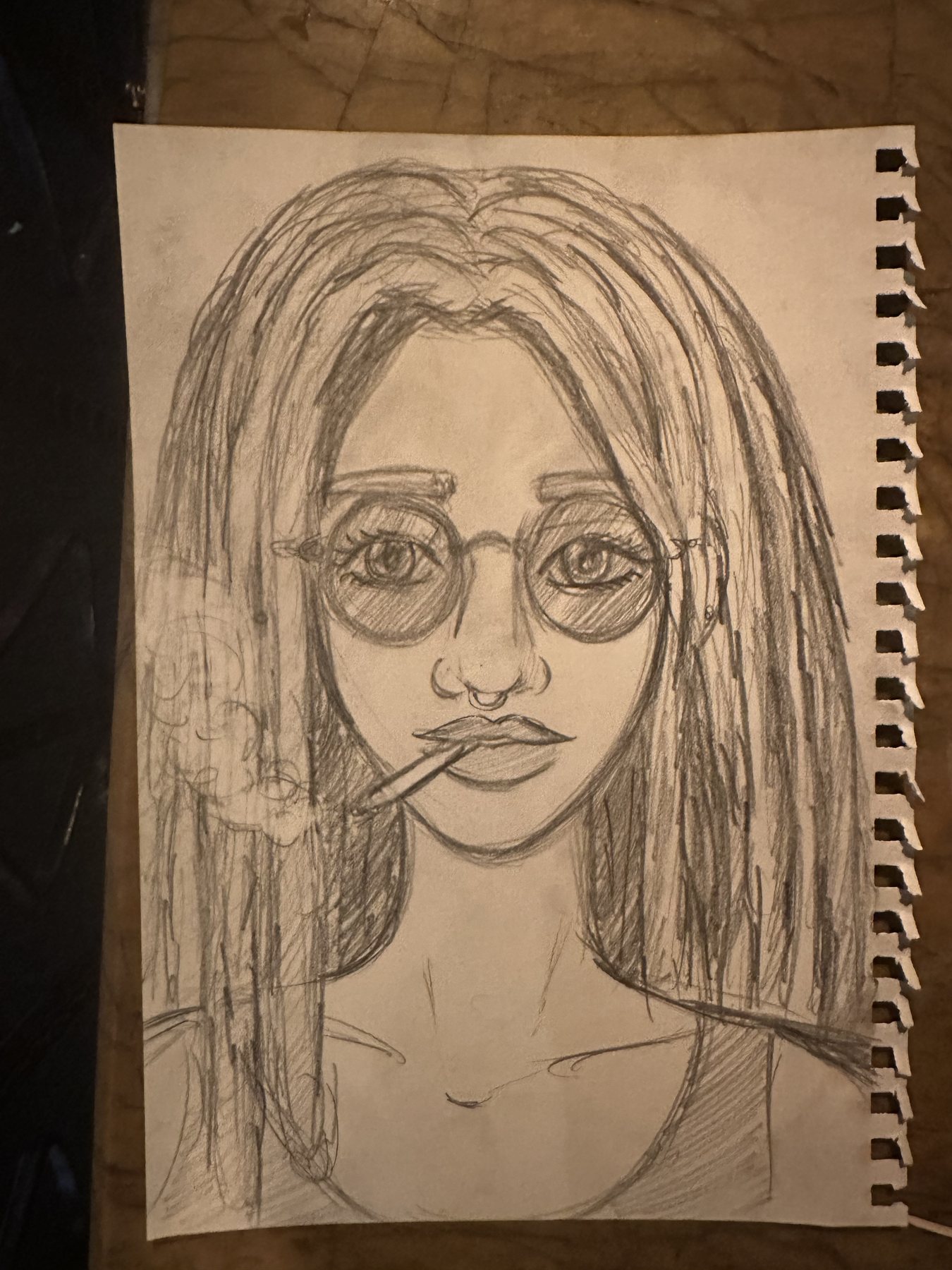 Graphite portrait study of a character with round glasses, heavy lashes and loose hair.